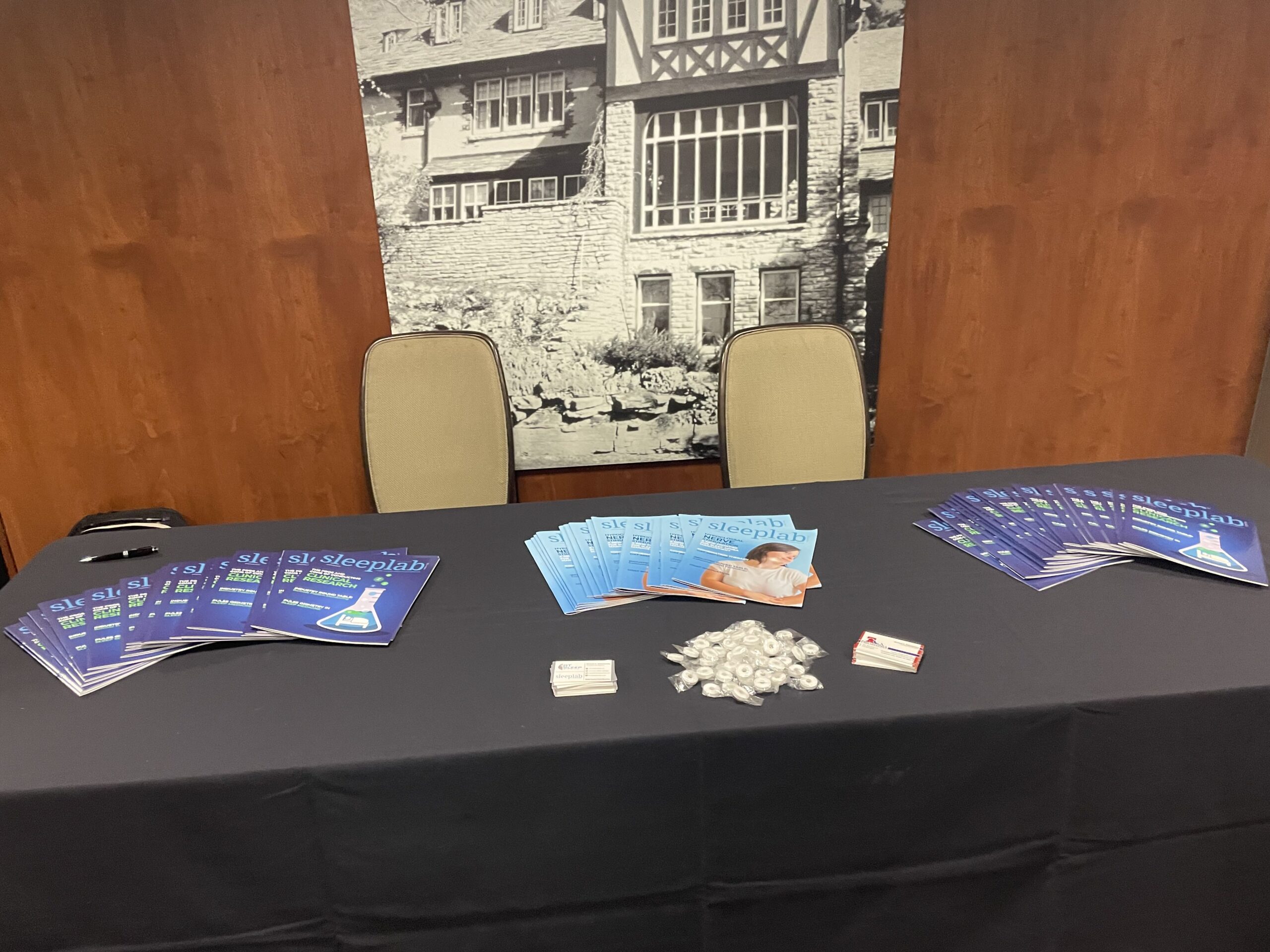RTSleepWorld Sleep Lab Magazine Table at Sponsor Banner at 2023 Wake Up Narcolepsy National Conference & Patient Summit in Rochester, Minnesota